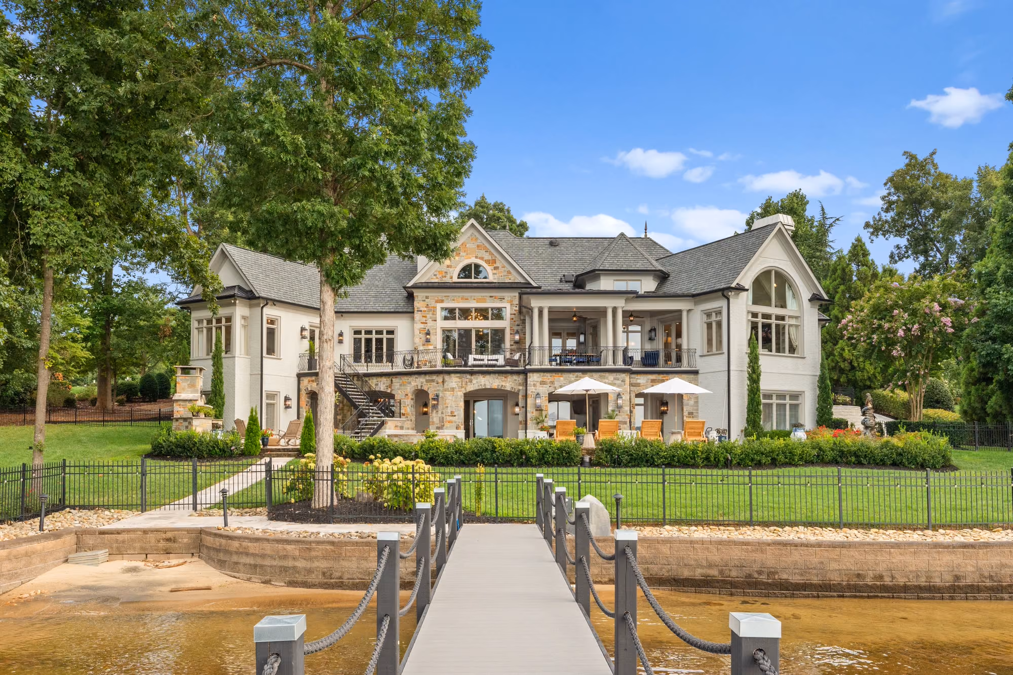 A stone house seen from the end of its own dock.
