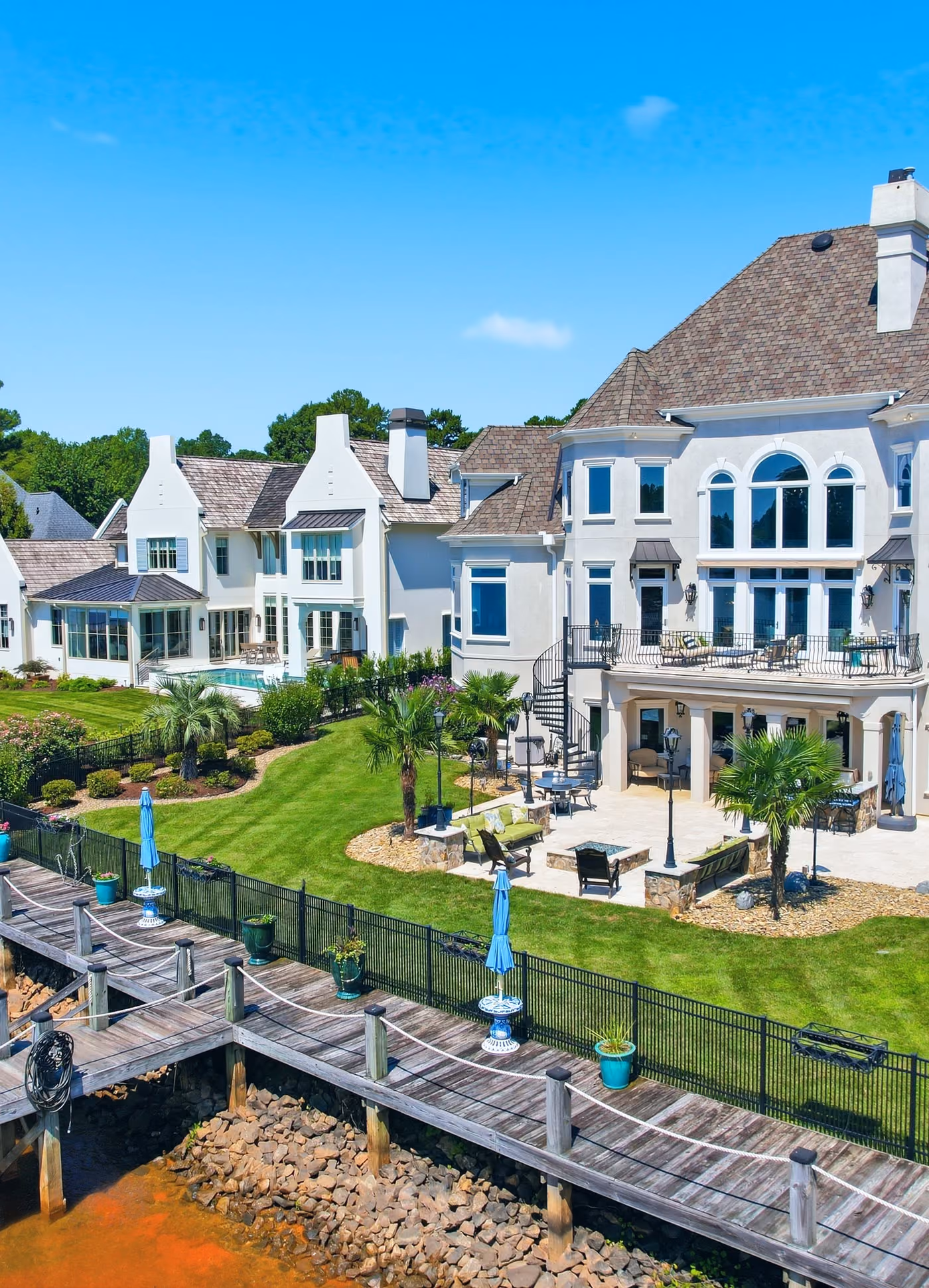 A lakefront house and its dock, seen from the water.