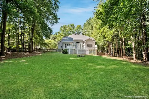 AWESOME backyard, surrounded by trees, yet plenty big to run and play! Grass is virtually enhanced in this image.