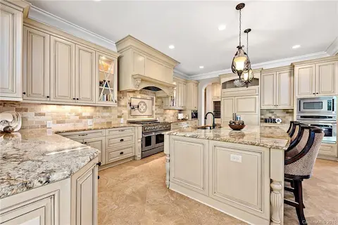 Large kitchen has microwave, wall oven, double oven in the range.
