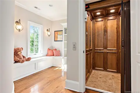 Elevator goes from top to bottom.  Here it opens up to the upstairs reading nook that has a window seat with storage.