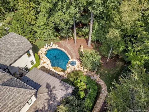 Bird's eye view of the private, wooded lot and pool area.