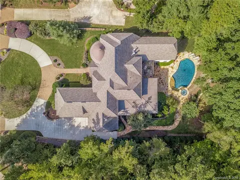 Aerial shot of the lovely custom home and the amazing backyard.