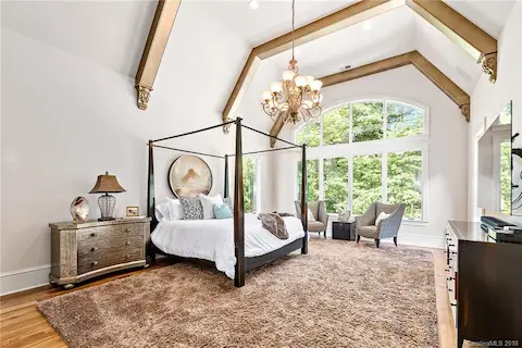 Spacious master suite on main.  The bedroom has painted beams, and cathedral ceilings.  Large windows let in natural light and offer great backyard views.