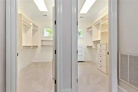 Large side by side his and hers closets in the master suite.  Master suite has its own hallway with refrigerator and wet bar/coffee area.