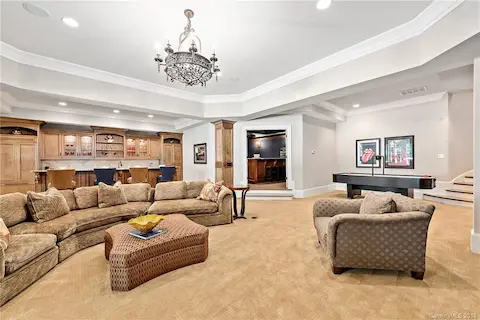 Large, open entertaining area with fireplace, display cabinets and built ins.