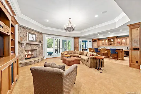 Stone fireplace makes this a cozy spot to unwind.  Access to covered porch and pool area.