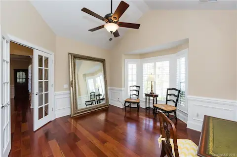Beautiful office with a bay window and plantation shutters! Vaulted ceilings make this space big and bright!