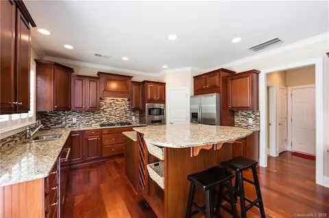 Two-tiered island with storage (and wine storage) on one side and wine/beverage fridge on the other!