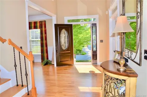 Handsome new upgraded exterior front door compliments the recently refinished hardwoods on main level.