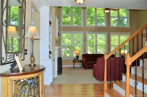 Wide open 2 story foyer leads to family room with a great wall of windows overlooking wooded backyard.  New wrought iron balusters on staircase.
