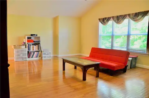 Large third floor media/ rec room/playroom with hardwood floors.  Walk up attic storage off this room.