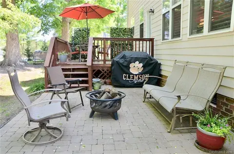 Deck extends down to pavers for additional seating for backyard gatherings.