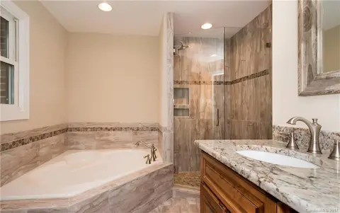 Beautiful bathroom with full tub and a shower.  The baths are all beautiful and well designed