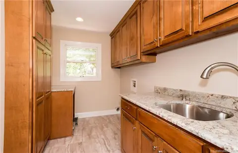 Upstairs laundry room has great storage, pantry storage and folding counter and laundry sink. Located conveniently just off the garage entry and adjacent to the kitchen