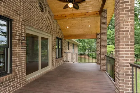 Warm wood ceiling adds to the charm of this porch and to the home. Wonderful porch to use for relaxation, entertaining or grilling out.