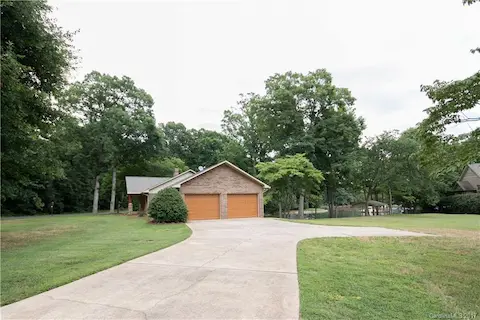 This view shows just how nice a lot this home comes with and has great parking spaces Beautiful mature trees surround the home with beauty and shade