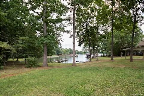 A view of the rear yard from the patio of the home. The pier in the picture belongs to the neighbor. The new pier will on the right side. Good deep water