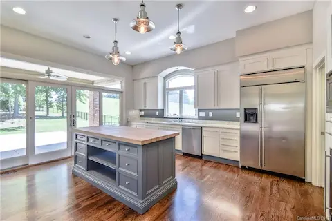 Upgraded kitchen with stainless steel appliances, granite, custom island & lighting & hardwood floors
