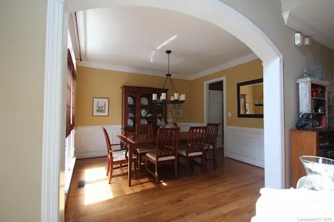 Formal dining room with arch entry.  Picture frame, chair rail  & crown molding.