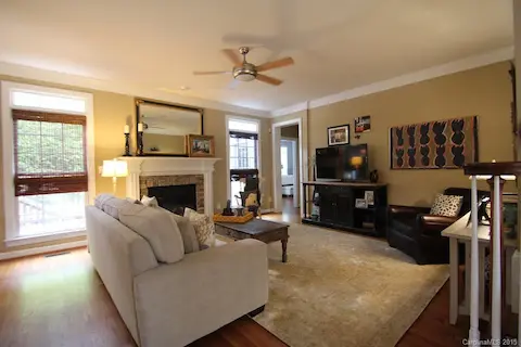 Open great room, gas fireplace with stone surround & fan.