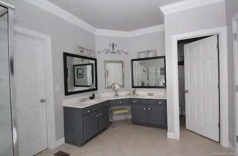 Master bath with tile floors ~ update mirrors and lighting.