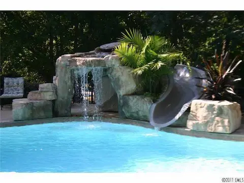 Swimming Pool - The pool also boasts a faux mountain slide with grotto and cascading waterfall!