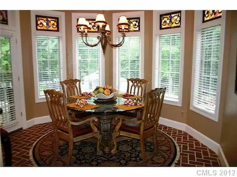 Breakfast - Spacious breakfast nook with rounded wall of windows, gorgeous custom stained glass transom windows, bonus bar seating in breakfast nook behind sink.