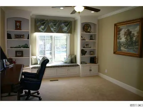 Office - Open the french doors and step into the office which boasts a beautiful window seat and custom bookshelves.