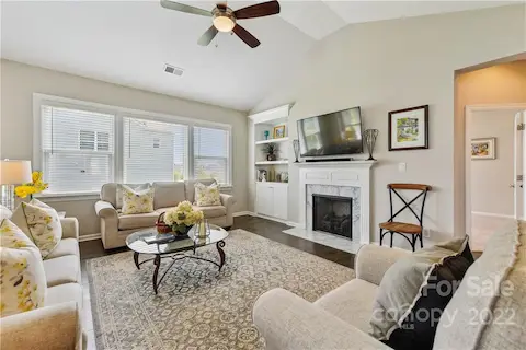 Great room with fireplace and built in cabinet.