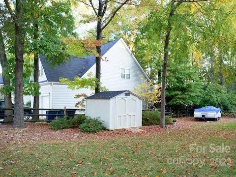 Large fenced yard with storage shed