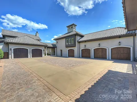 Motor court featuring six car garage & golf cart garage