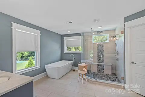 primary ensuite bathroom with large shower and soaking tub