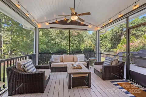 Screened porch overlooking large wooded back yard