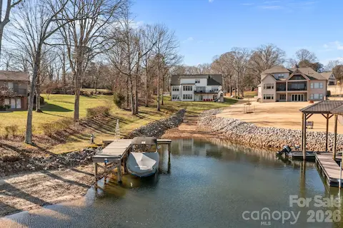 View of the home, dock, and boat ramp from the water