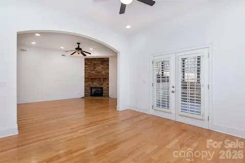 Basement grand area with stone fp and arched opening to office/band/hobby/maybe future kitchen with dbl doors to private entry and patio.