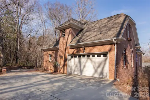 Large parking pad - 18 ft garage door -with Mint Hill and HOA Architectural approval, lot may allow detached garage.