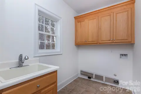 Dbl doors from kitchen open to laundry and exit to garage on main level. Laundry stg closet.