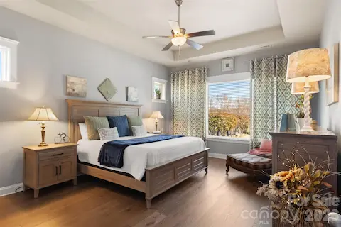 Large primary bedroom with tray ceiling