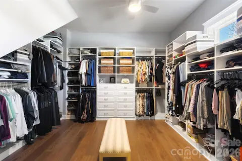 This is a dream closet with custom organization shelves and cabinets