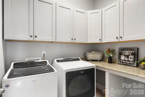 Main floor laundry room with folding counter and custom cabinets