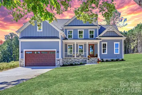 Beautifully crafted, new construction home featuring lake views, high-end finishes, an open-concept living space, and outdoor entertaining areas.