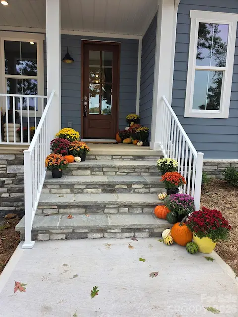 The front porch is an open canvas to add comfortable seating, a swing, and tasteful decorations, creating an inviting atmosphere.