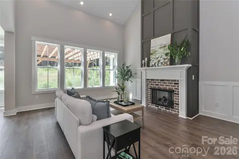 The stunning and cozy gas fireplace anchors the living room with warmth and elegance.