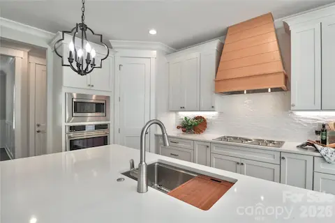 Featuring stainless steel appliances with custom cabinetry.