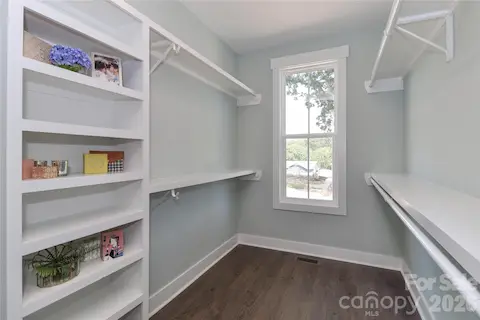 With an oversized walk-in primary closet, organization and storage spaces are abundant.