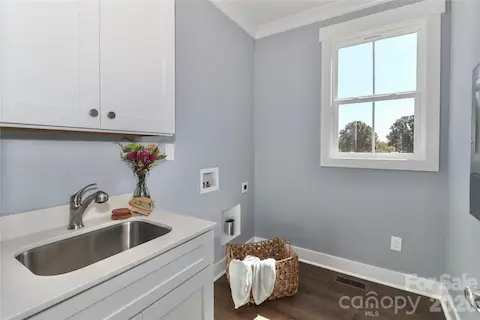 The conveniently placed laundry room offers practicality and ease, streamlining household chores.
