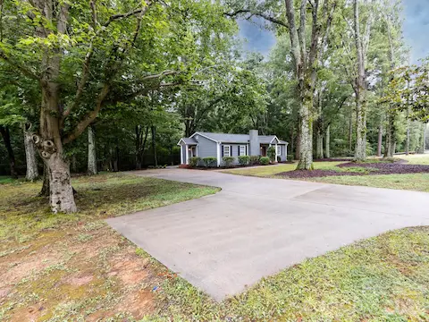 Elongated driveway with additional parking pad