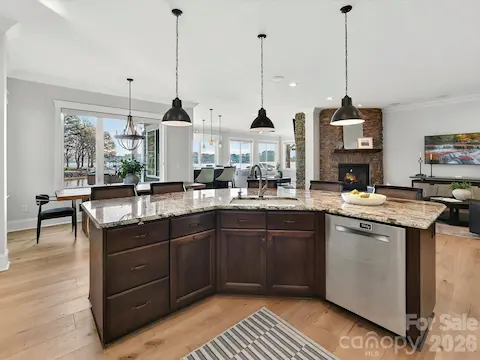 The heart of the home is this spacious chef's kitchen featuring custom cabinetry, high-end stainless steel appliances, generous counter space, and an oversized island perfect for gathering.