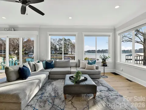 Bright and inviting Great Room offers panoramic Lake Norman views, abundant natural light, a cozy stone fireplace, and an open-concept design that flows effortlessly into the kitchen and dining areas.